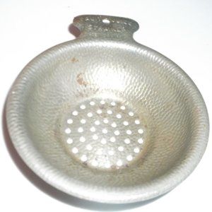 antique metal juice strainer. by pruit.